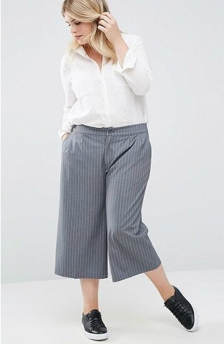 Женщина в plus size полосатых бриджах